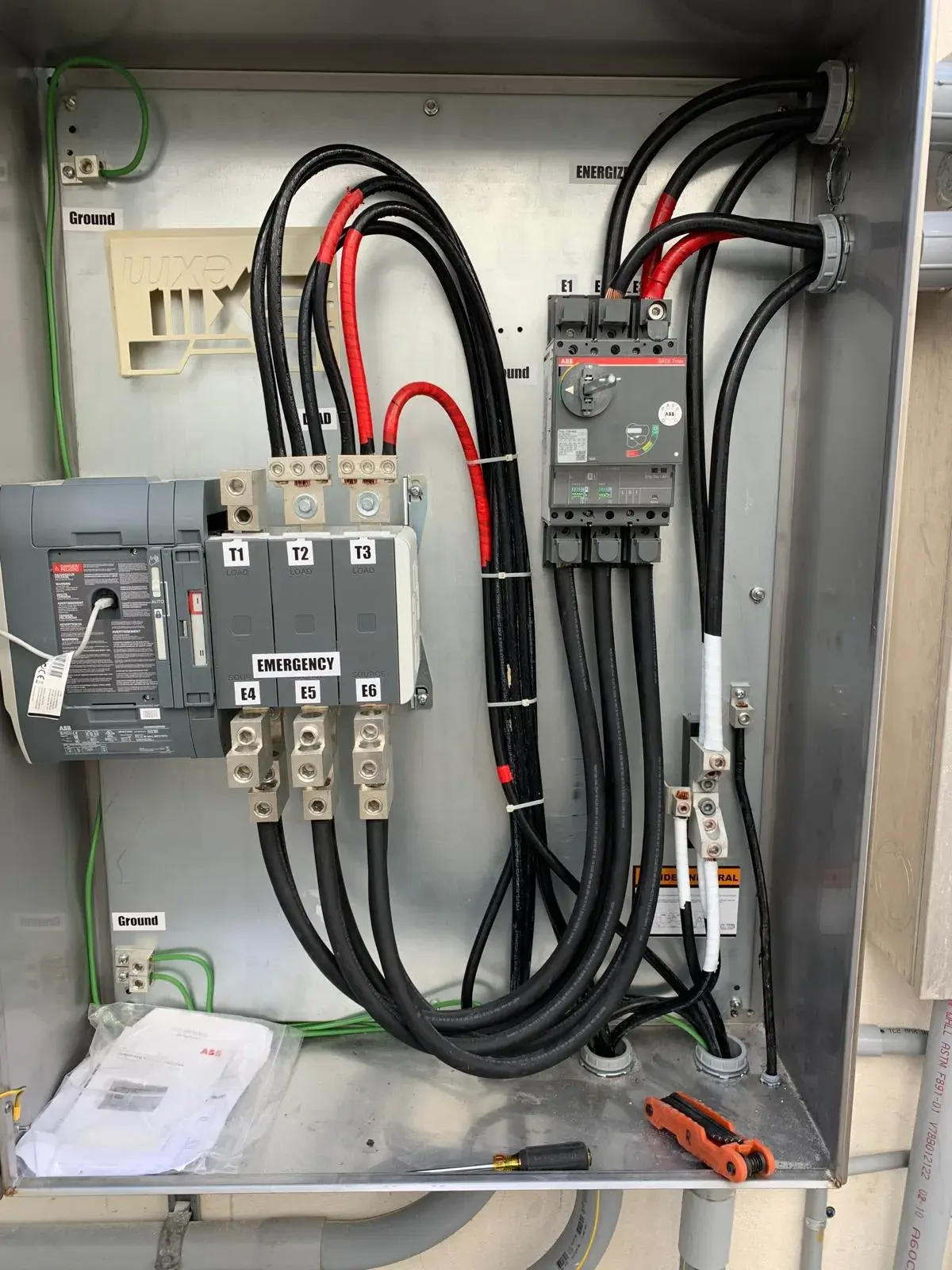 Automatic transfer switch enclosure with labeled conductors and breaker